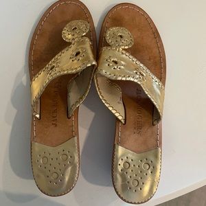 Jack Rogers gold sandals with a small wedge heel